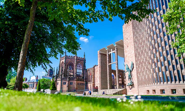 Side view of Coventry Cathedral ruins on a sunny day
