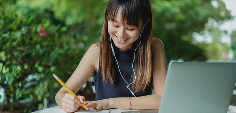 Woman working on a laptop outside